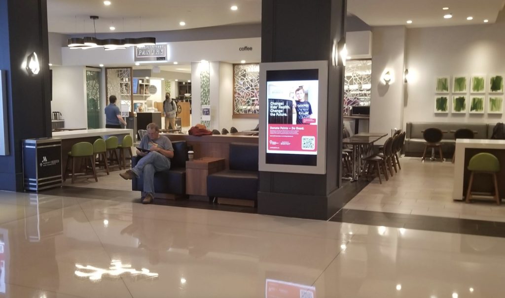 a man sitting on a bench in a mall