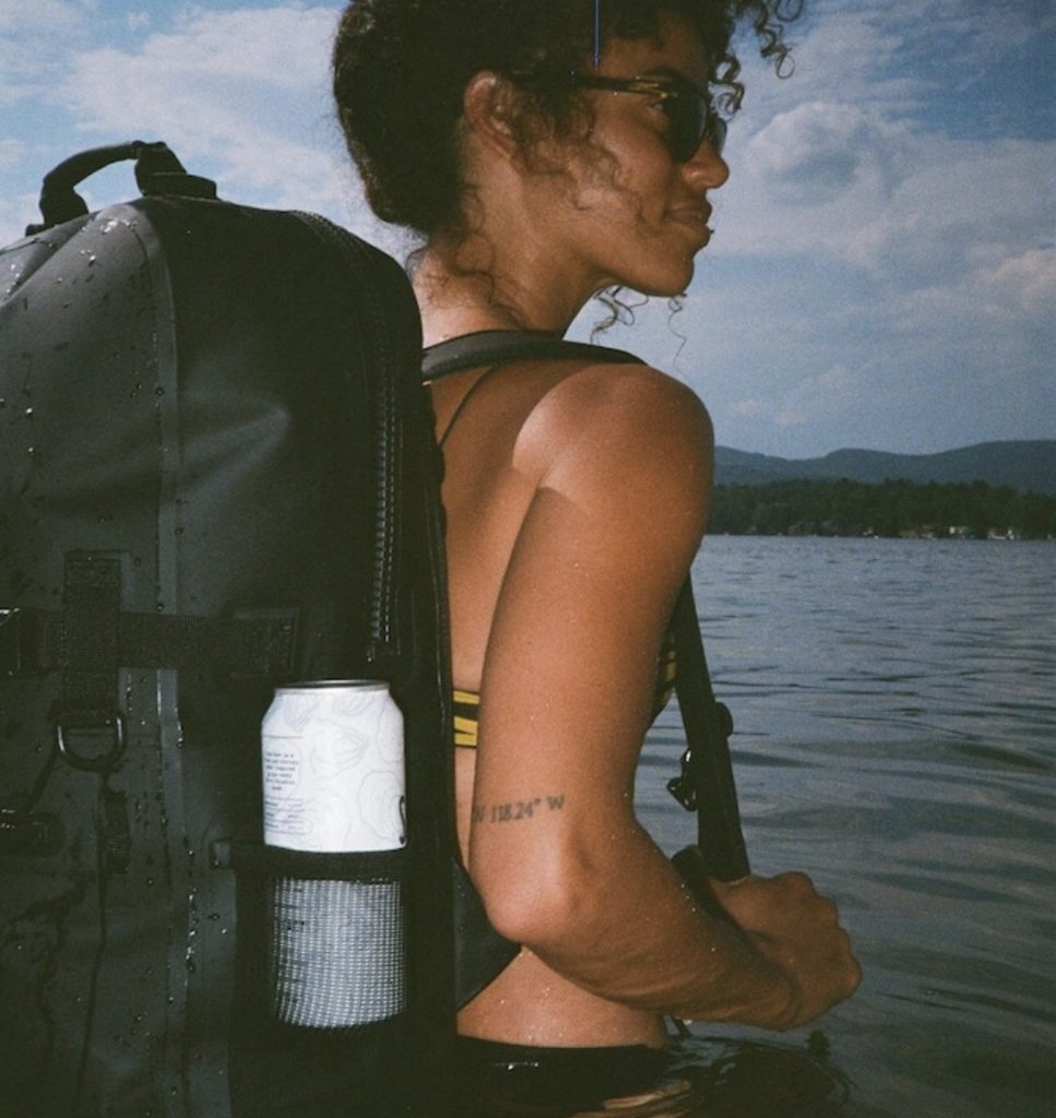 a woman in a swimsuit with a backpack in the water
