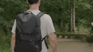 a man walking with a backpack