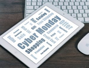 a tablet on a desk next to a keyboard