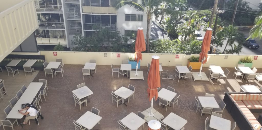 an outdoor patio with tables and umbrellas