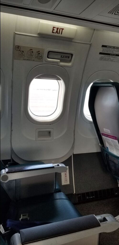 an airplane window with seats and seats