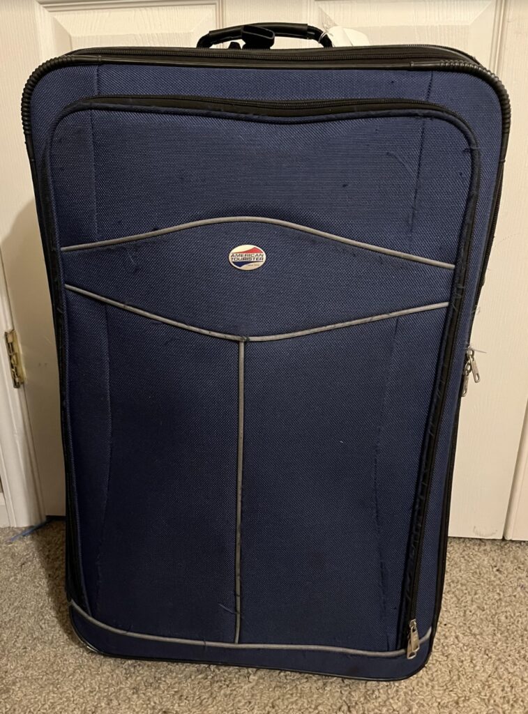 a blue suitcase on carpet