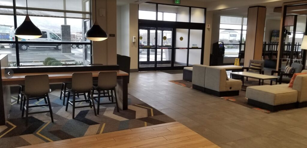 a lobby with a table and chairs