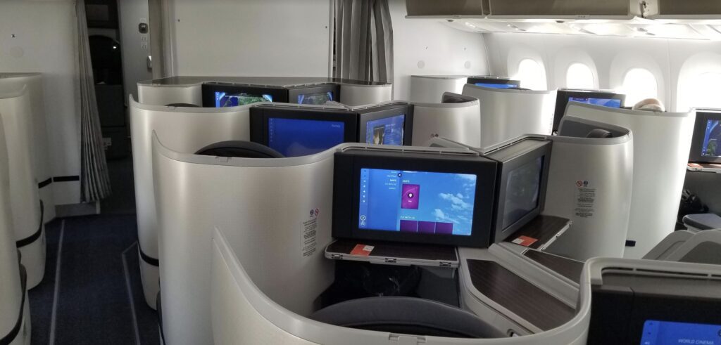 a row of monitors on an airplane
