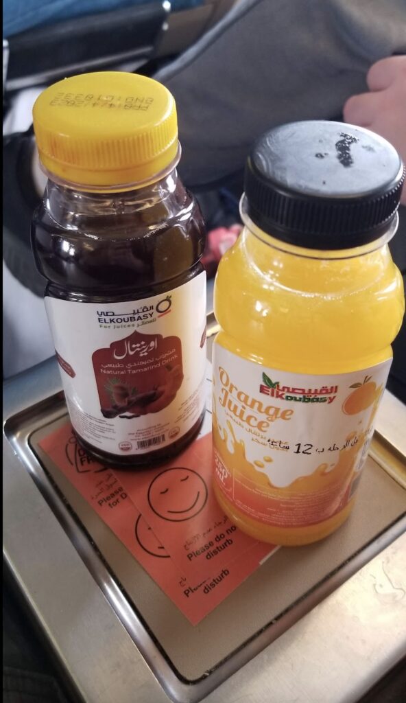 two bottles of juice on a tray