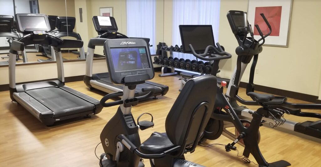 a room with exercise bikes and a mirror