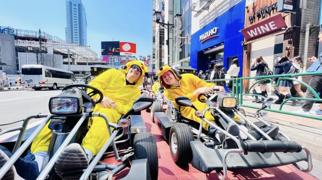 two people in yellow suits on go karts