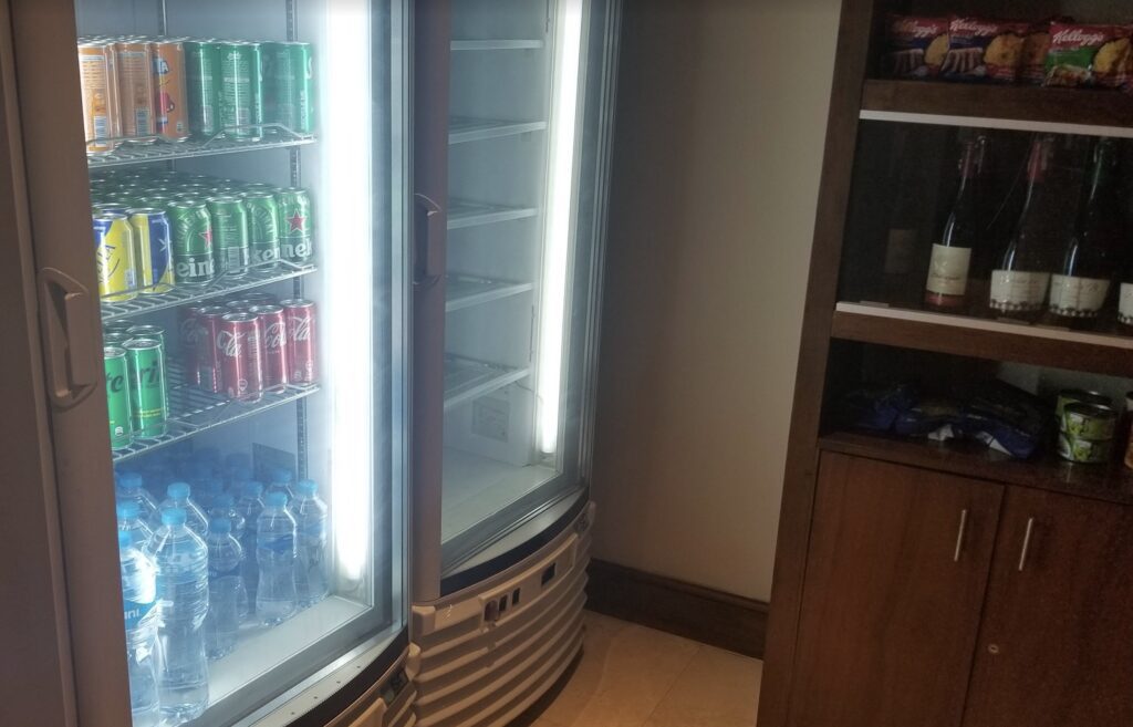 a refrigerator with cans of soda and water