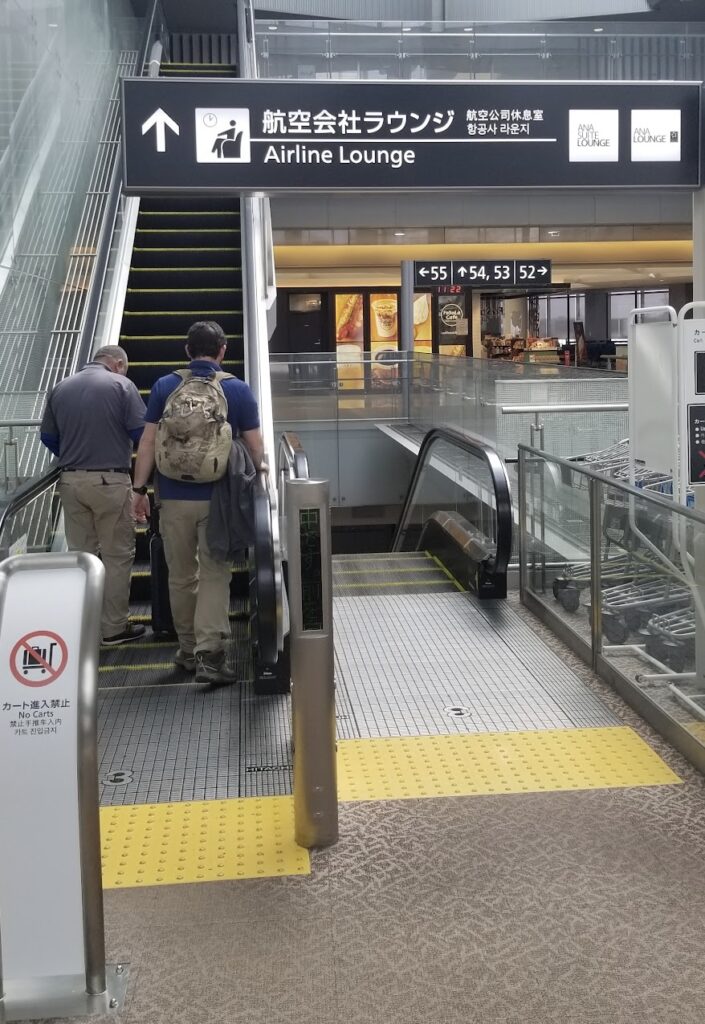 people walking up an escalator