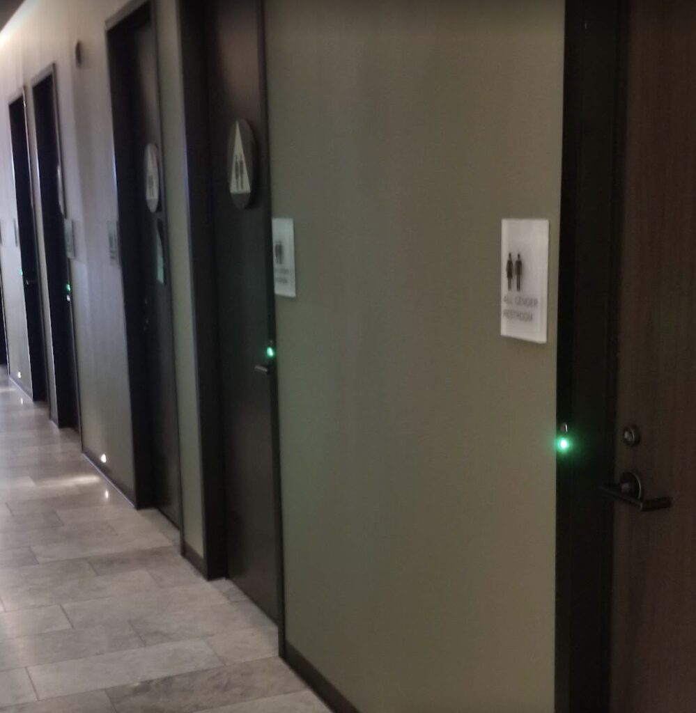 a row of doors with green lights