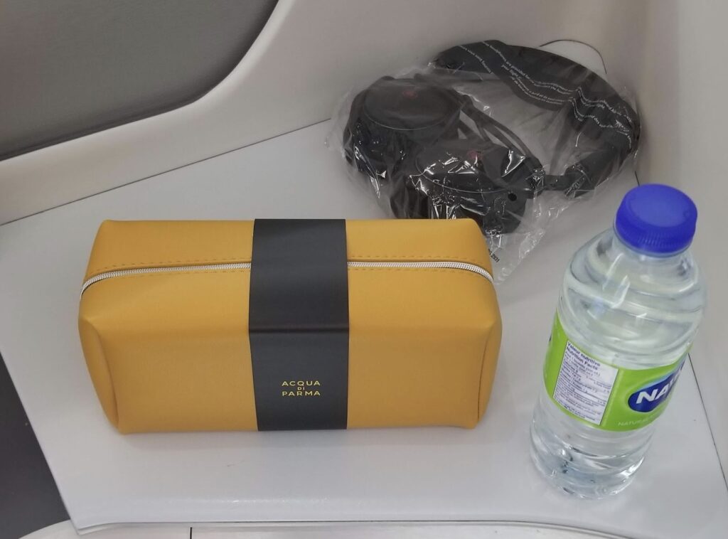 a bag and a bottle of water on a table
