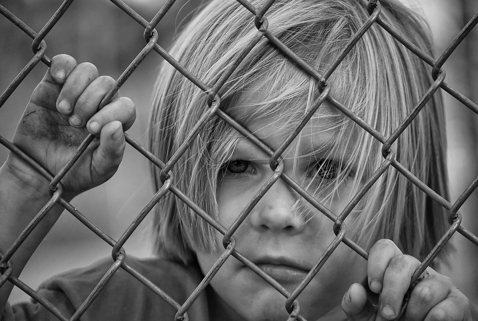 a child behind a fence
