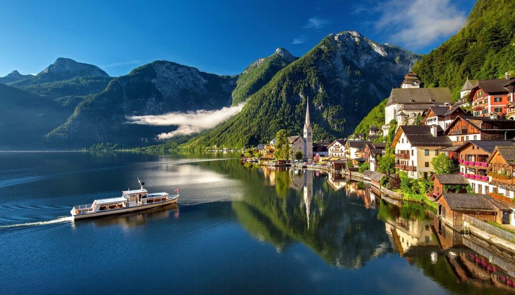 a boat on the water with Hallstatt in the background