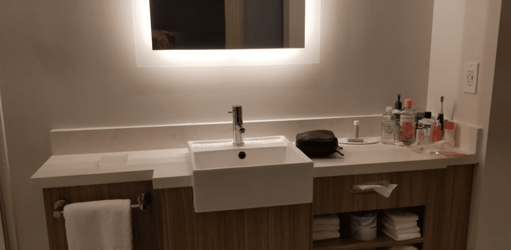 a sink and mirror above a counter