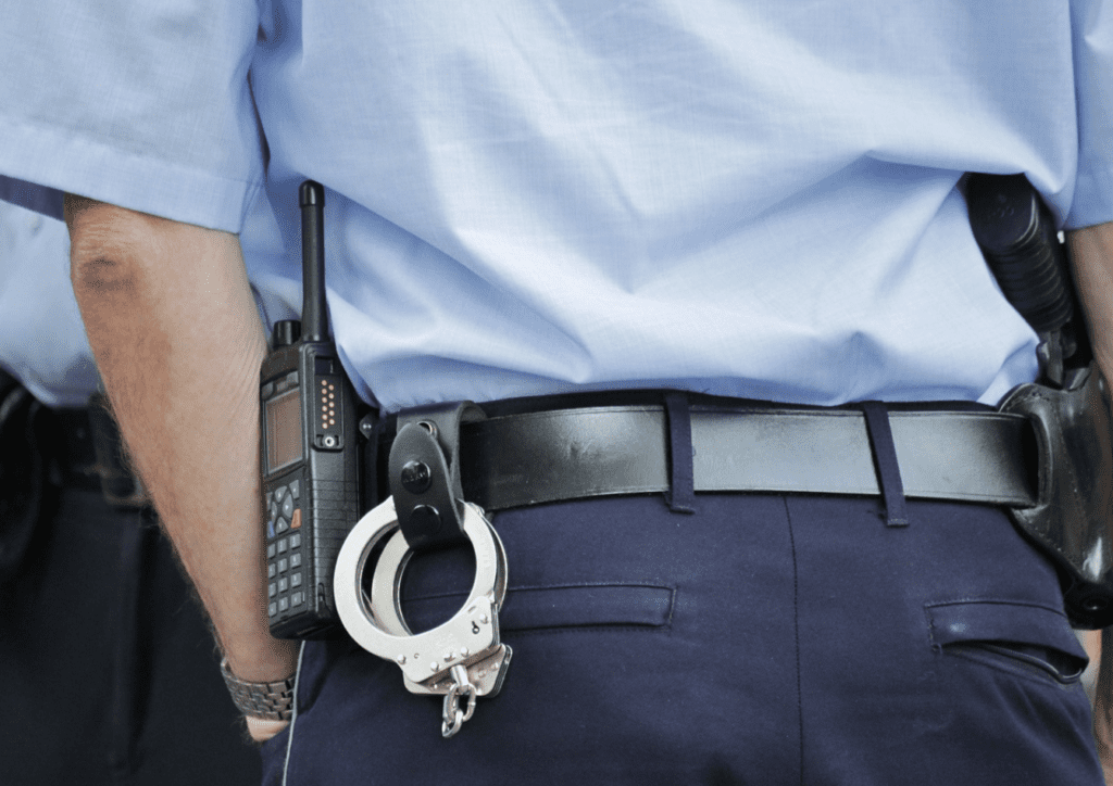 a police officer with handcuffs on his belt