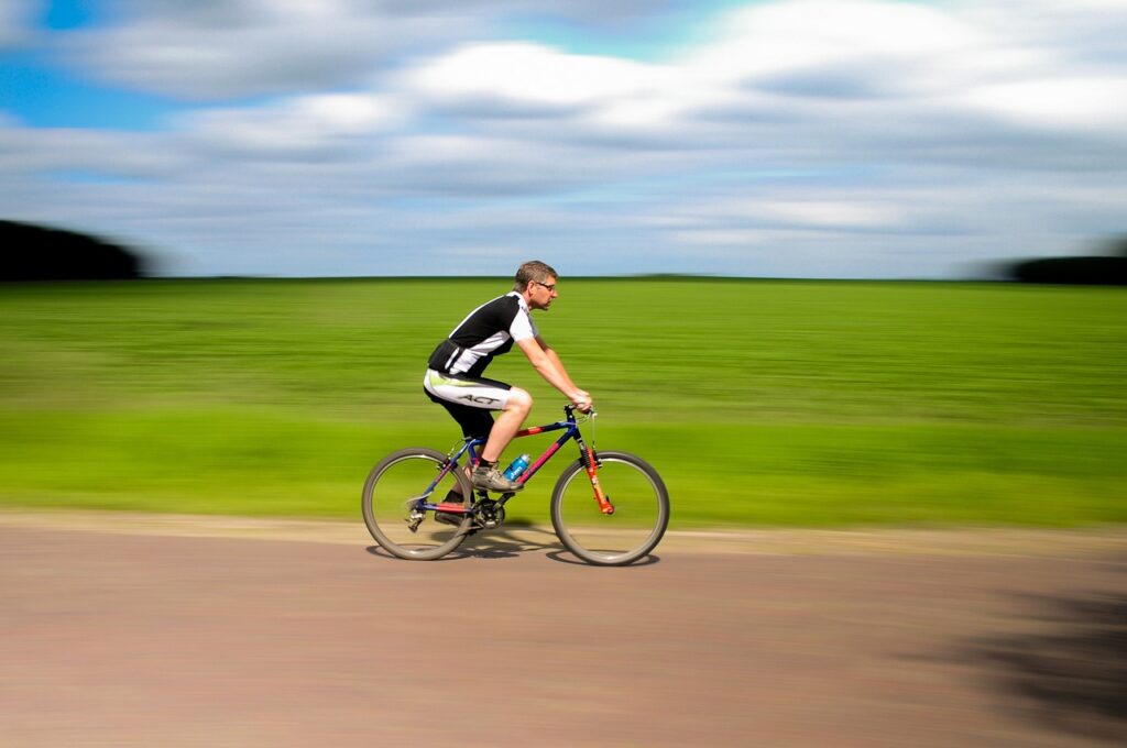 a man riding a bicycle on a road