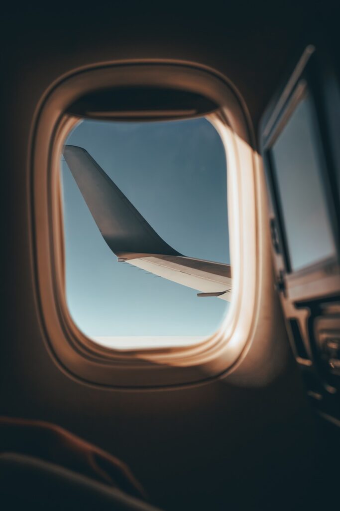 an airplane window with a view of the wing of an airplane
