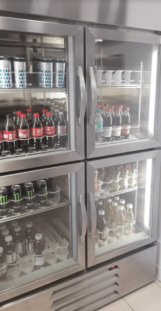 a refrigerator with bottles and cans