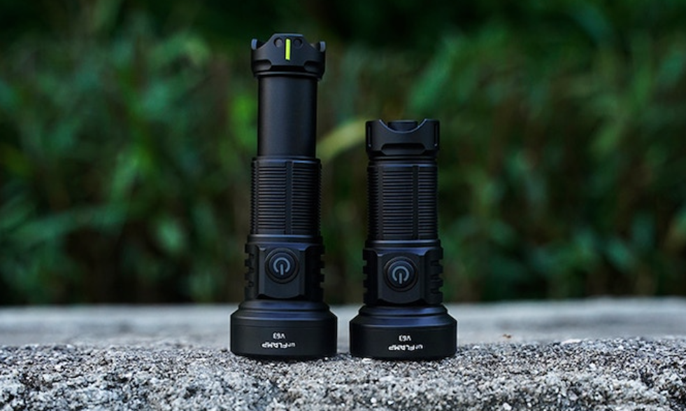 two black flashlights on a concrete surface