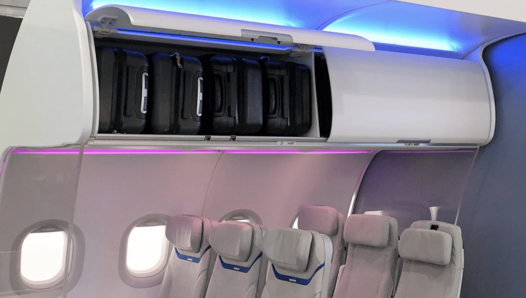 a group of luggage on a shelf in an airplane