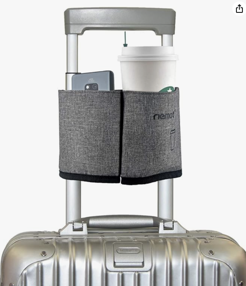 a luggage with a phone and a cup