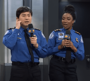 a man and woman in uniform holding microphones