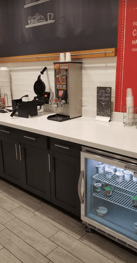 a counter with a machine and a refrigerator