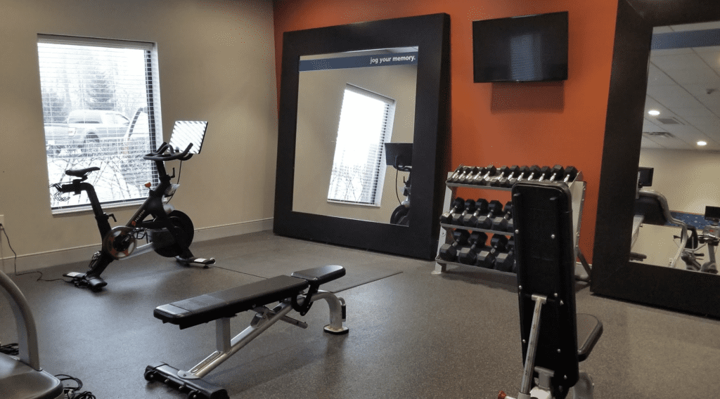 a mirror in a room with exercise equipment
