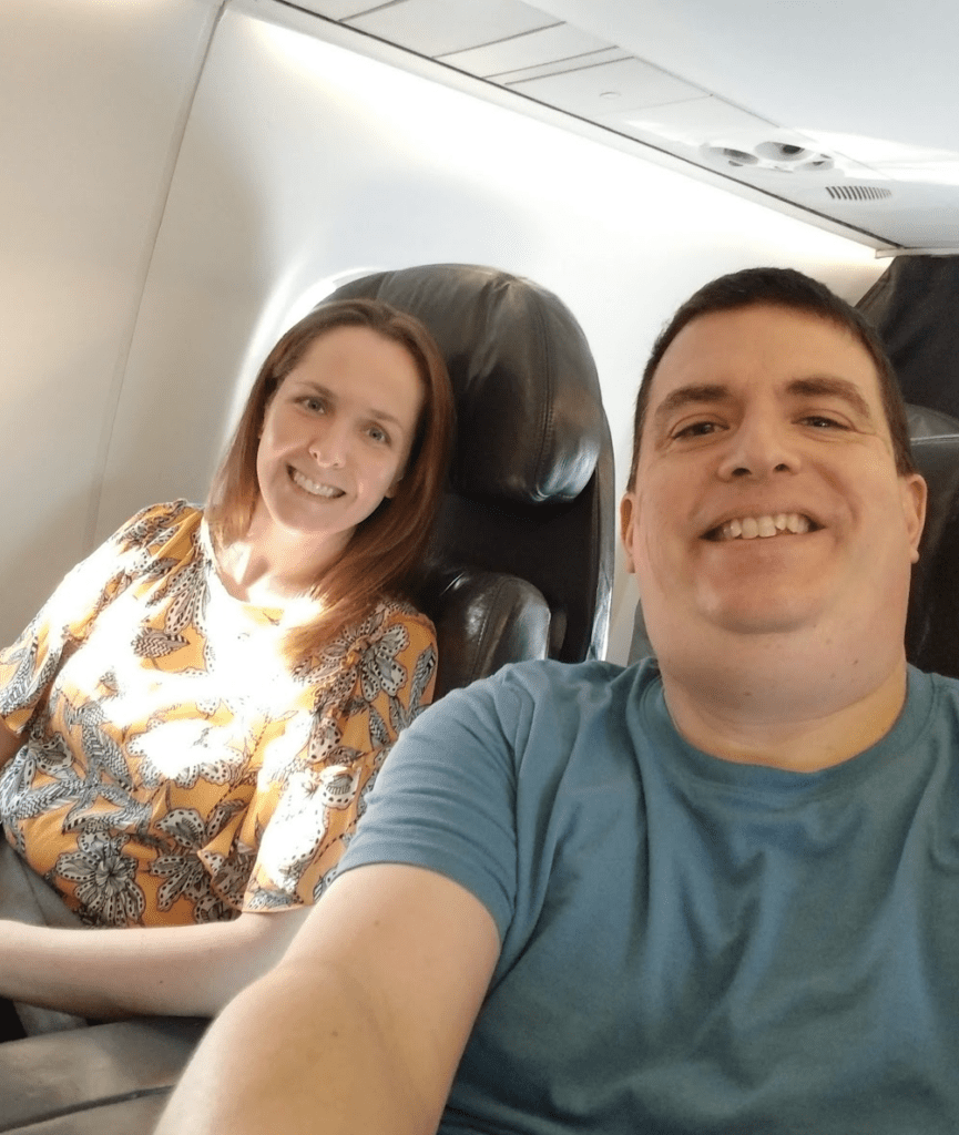 a man and woman sitting in an airplane