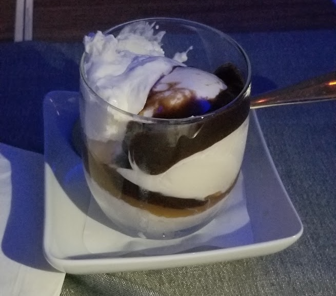 a glass cup with a spoon on a plate