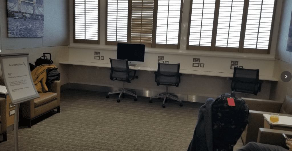 a room with a computer and chairs