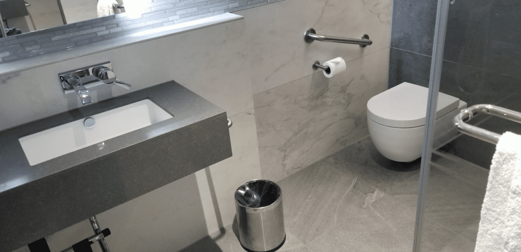 a bathroom with a sink and trash can