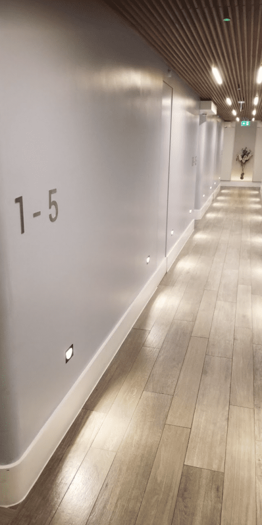 a long hallway with lights on the wall