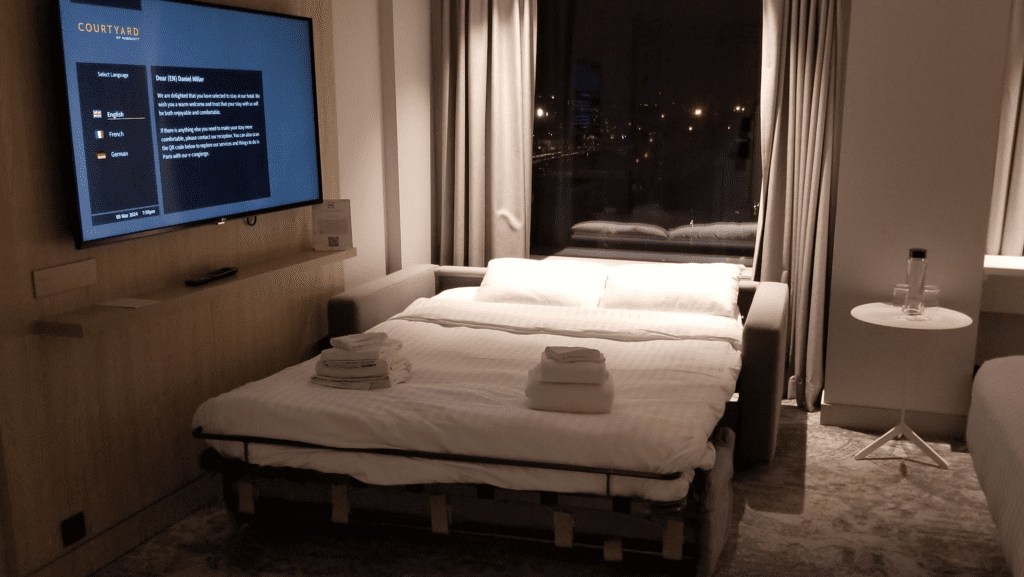 a bed with a couch and a television