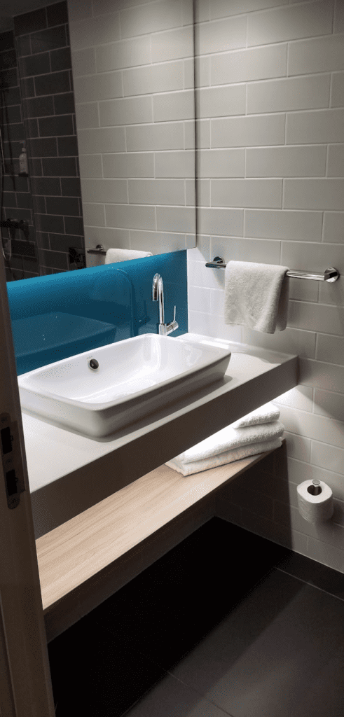 a bathroom with a sink and towel rack
