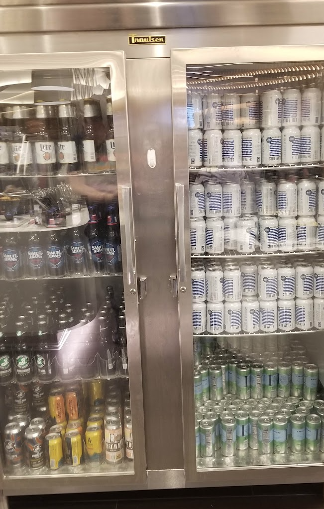 a glass case with many cans of beer