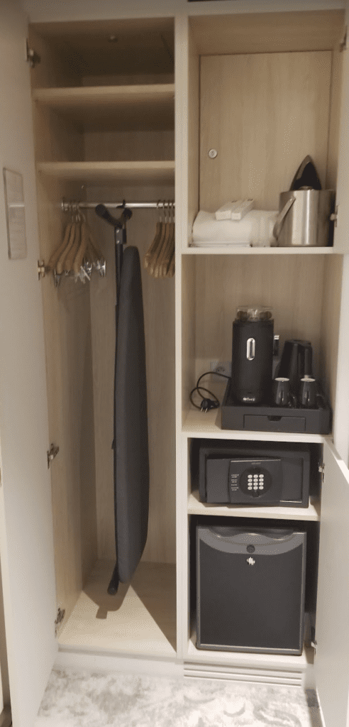 a closet with a coat rack and swingers
