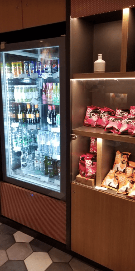 a display case with drinks and snacks