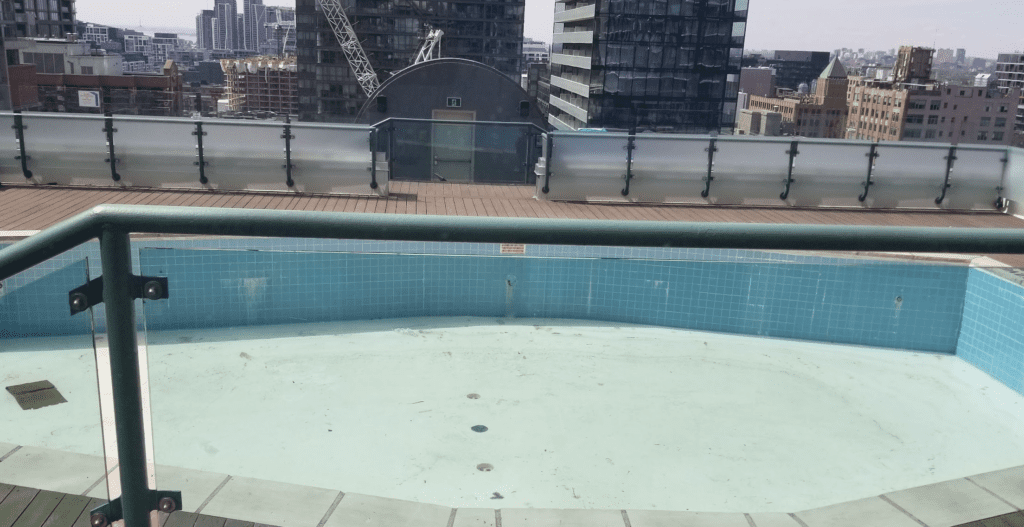 a pool with a building in the background