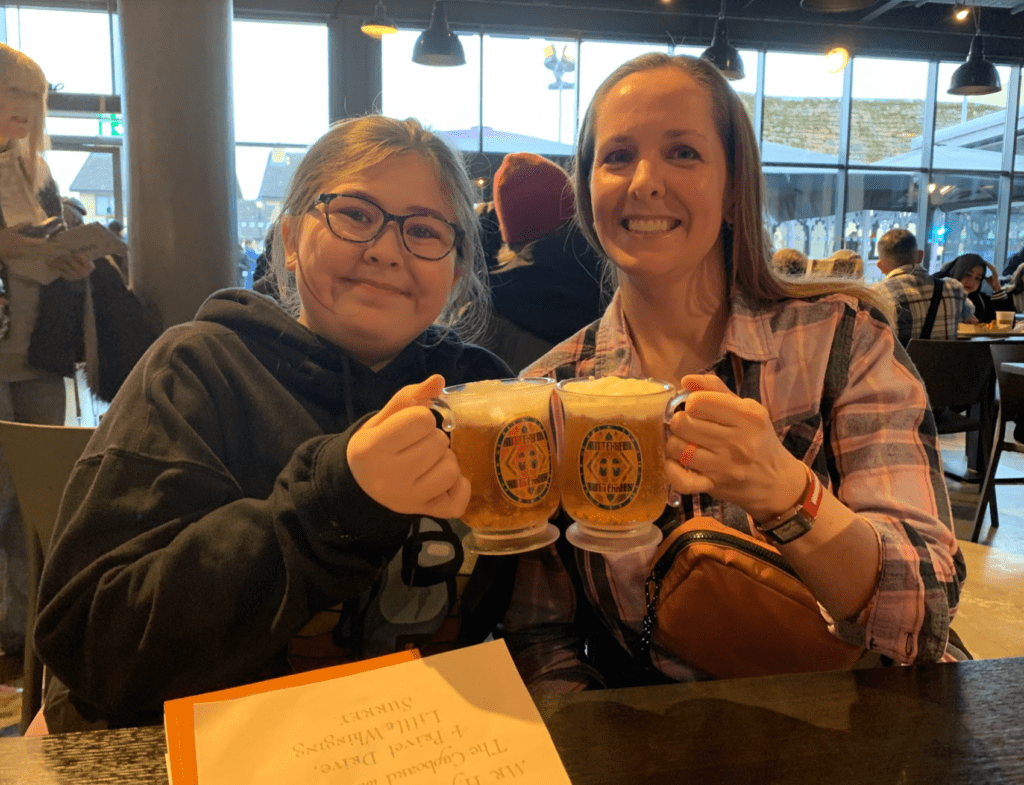 two women holding mugs of beer
