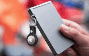 a hand holding a keychain on a laptop