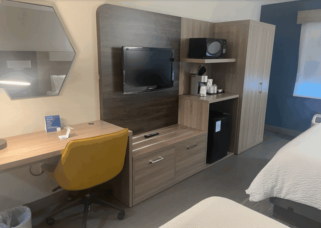 a room with a tv and a desk
