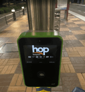 a green and black device with a screen on a pole