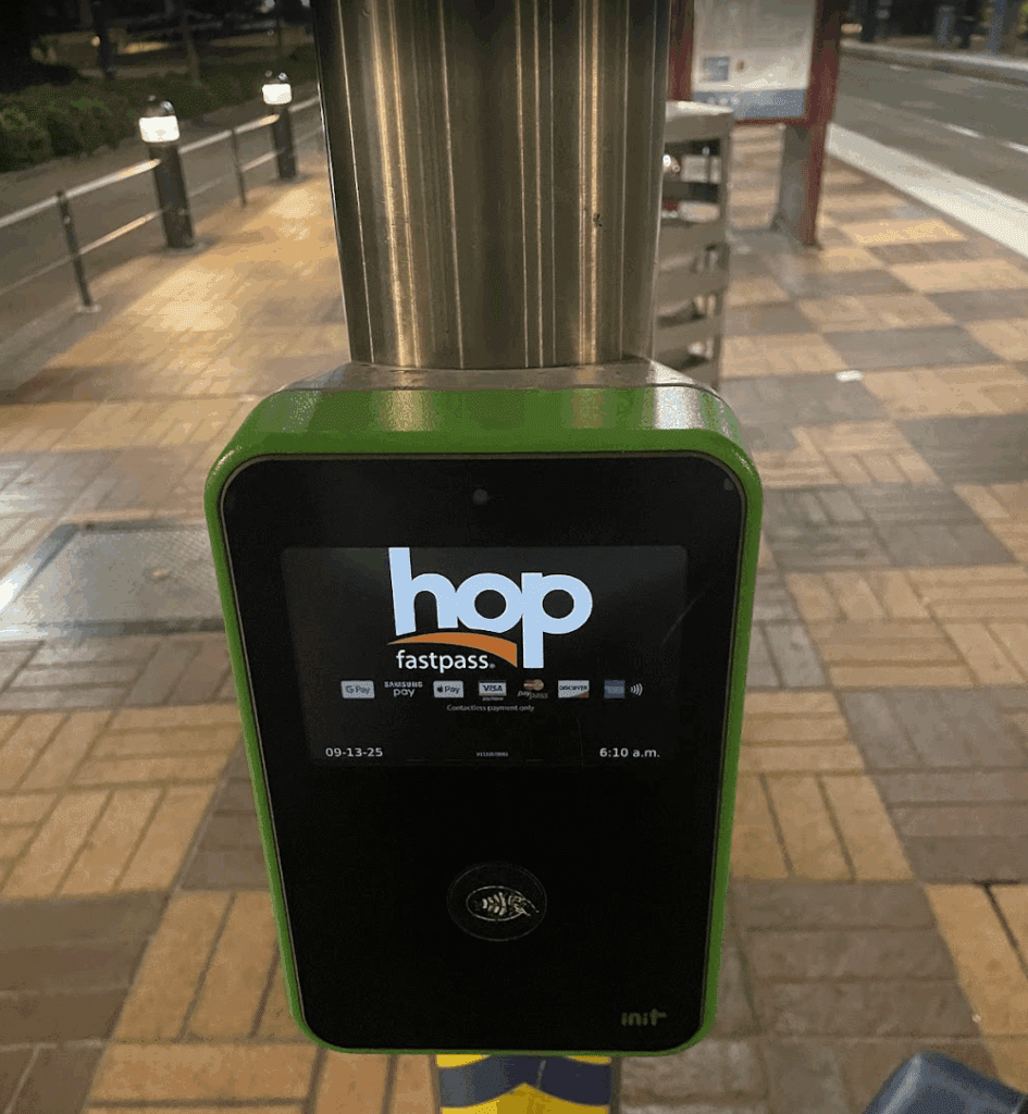 a green and black device with a screen on a pole