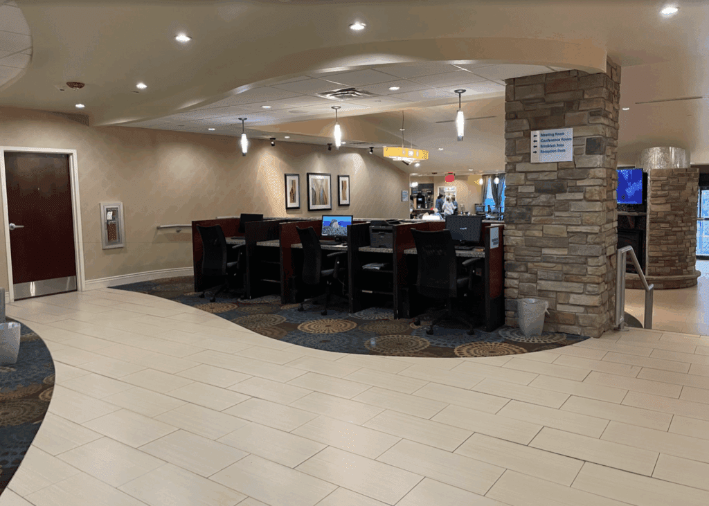 a room with a stone column and a stone pillar and a stone wall