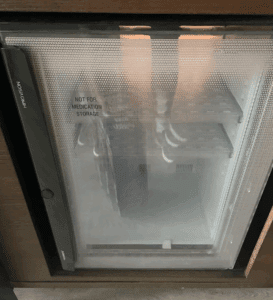 a small refrigerator with a glass door