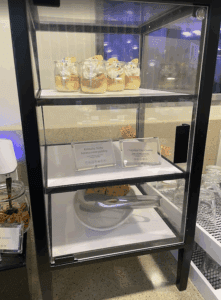 a glass display case with desserts on it