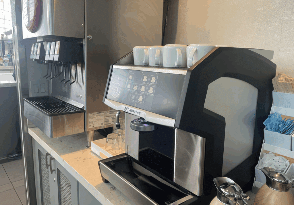a coffee machine with white cups on top