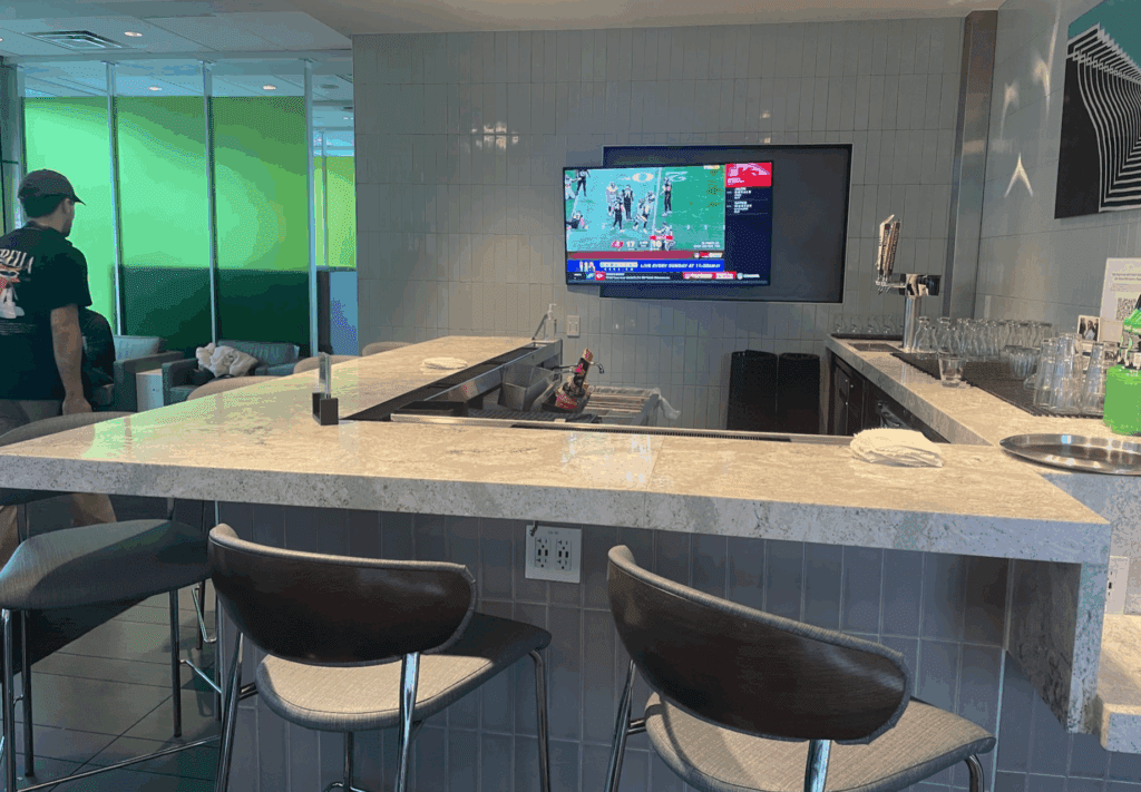 a bar with a television and a tv on the wall